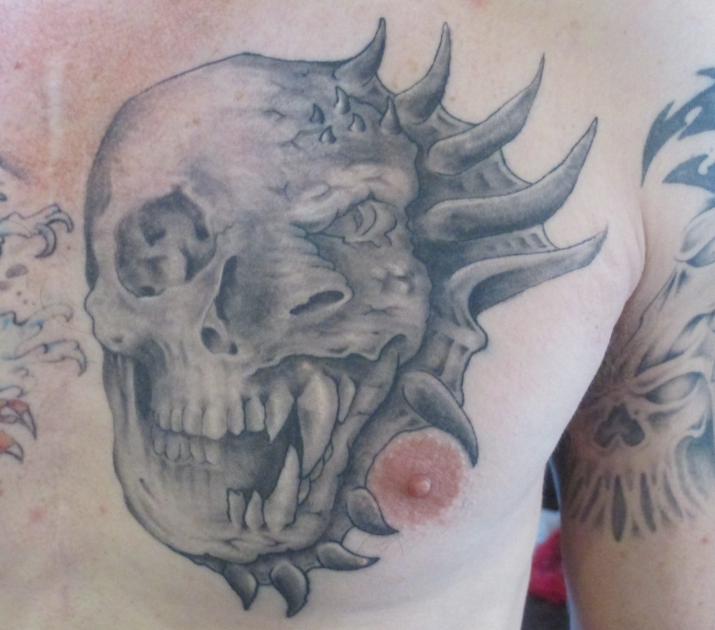 Copyright 2012 Artistic Prick Tattoos Skull.Dragon
